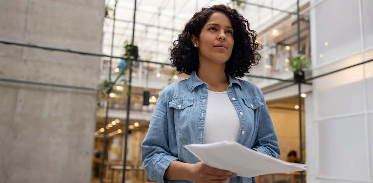 woman-with-paper-walking-through-office (1)